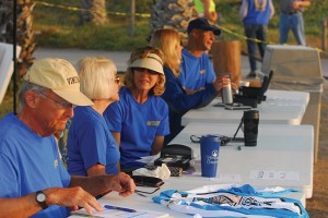 Early morning at Imperial Beach’s Camp Surf, Rotarians greet racers at the Registration Desk.