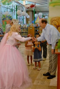 Christian Esquevin, director of library services for the city of Coronado, welcomes Glenda the Good Witch (Marty Brooks) to the library’s kick-off celebration of Oz Con.